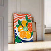 A kitchen scene featuring citrus fruits in bright orange and blue tones - leaning on a herringbone floor against a white panelled wall