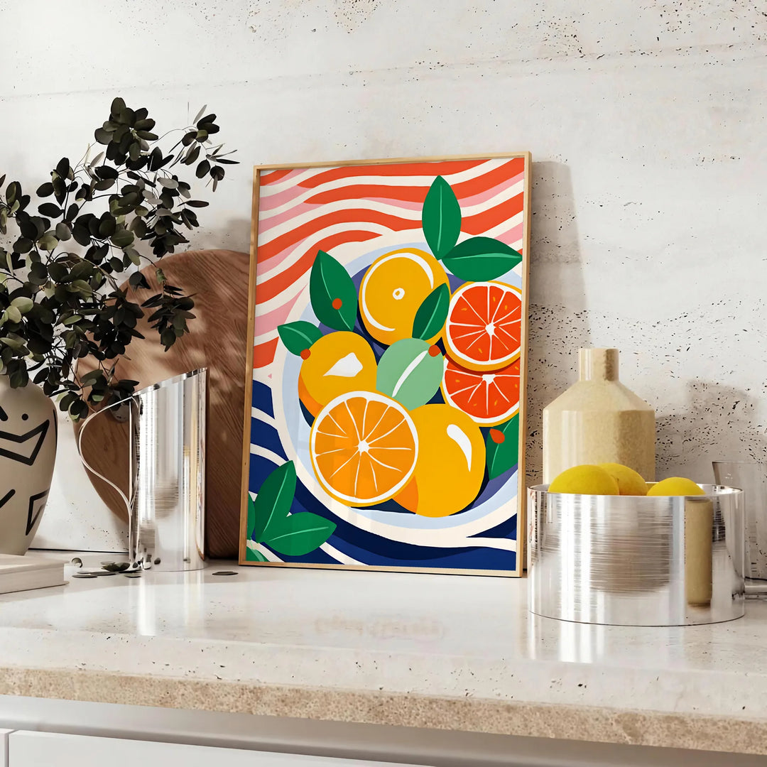 A kitchen scene featuring citrus fruits in bright orange and blue tones - styled on a counter with eucalyptus and a bowl of lemons
