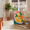 A kitchen scene featuring citrus fruits in bright orange and blue tones - in a Parisian living room with a sofa and a fig plant
