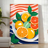 A kitchen scene featuring citrus fruits in bright orange and blue tones - in a bright minimalist room with a plant and an armchair