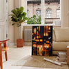 Abstract representation of a Japanese cityscape with orange and black tones - in a Parisian living room with a sofa and a fig plant