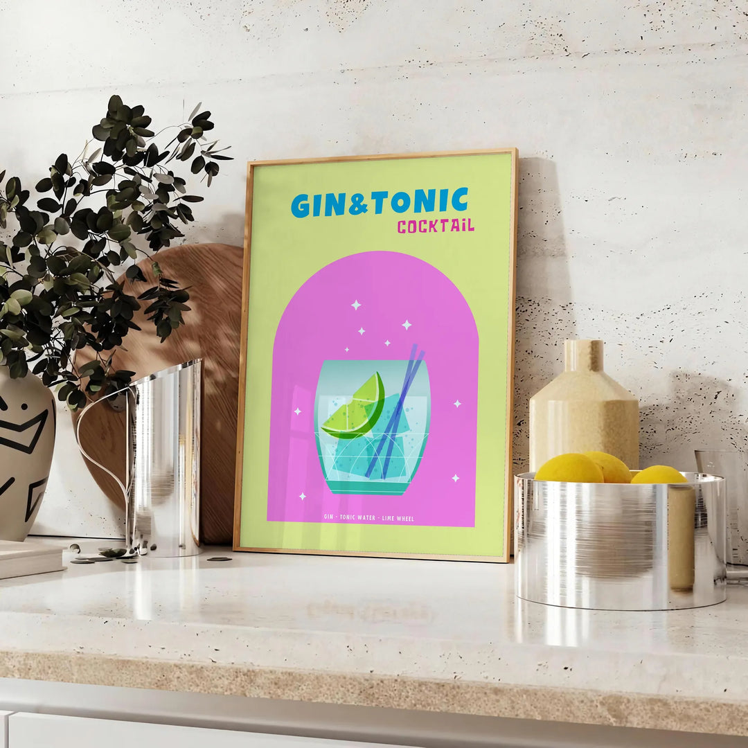 A gin and tonic cocktail in a glass with green and blue hues - styled on a counter with eucalyptus and a bowl of lemons