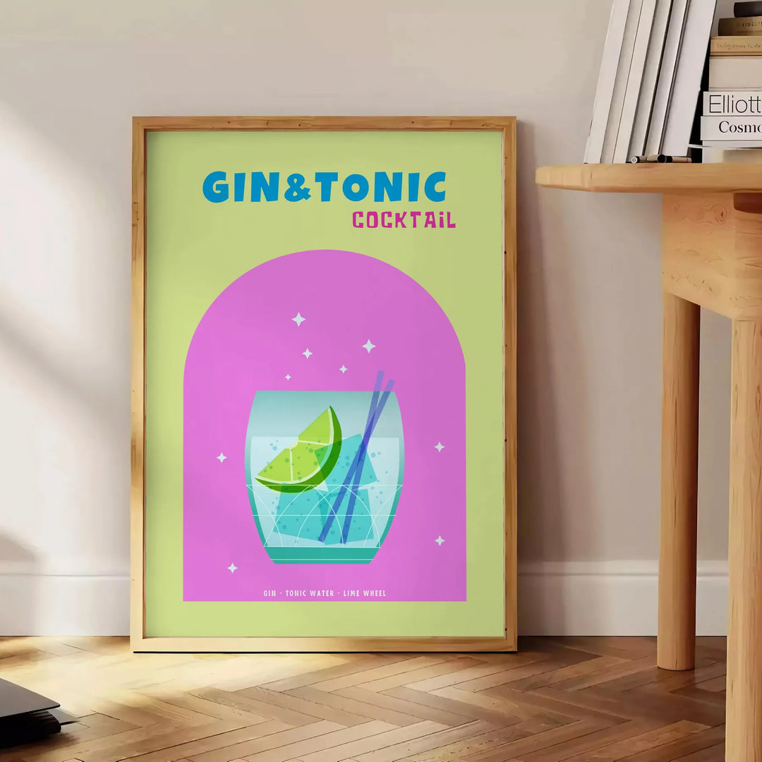 A gin and tonic cocktail in a glass with green and blue hues - beside a round wooden side table with books