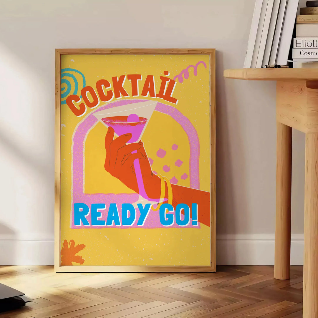 An abstract cocktail illustration with orange and blue splashes - beside a round wooden side table with books