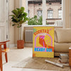 An abstract cocktail illustration with orange and blue splashes - in a Parisian living room with a sofa and a fig plant