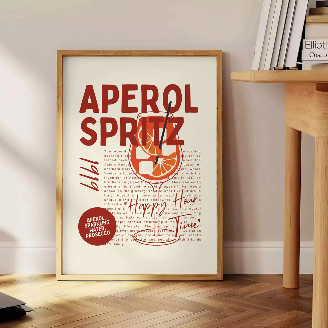 Une illustration de cocktail spritz dans des tons gris et rouges - à côté d'une table d'appoint ronde en bois avec des livres