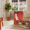 Communism Travel Poster featuring bold orange and brown colors in a vintage style - in a Parisian living room with a sofa and a fig plant