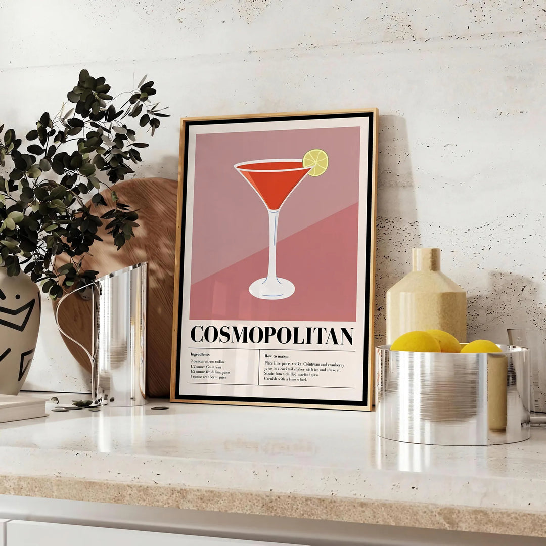 Cocktail cosmopolita in un bicchiere su uno sfondo cosmico - su un piano con eucalipto e una ciotola di limoni