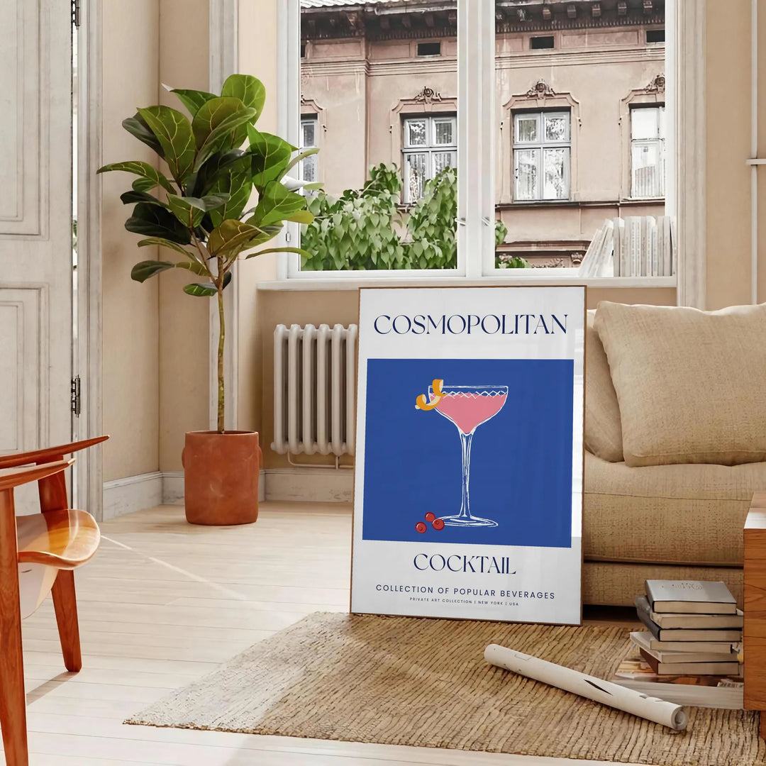 A stylish illustration of a cosmopolitan cocktail against a blue backdrop - in a Parisian living room with a sofa and a fig plant