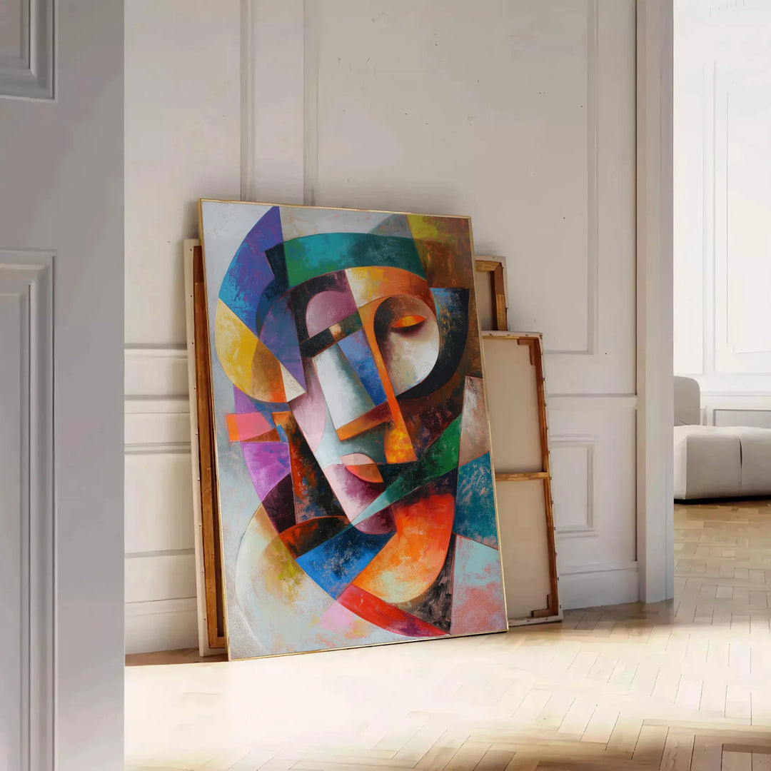 Cubist artwork featuring geometric shapes in gray and blue tones - leaning on a herringbone floor against a white panelled wall