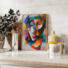 Cubist artwork featuring geometric shapes in gray and blue tones - styled on a counter with eucalyptus and a bowl of lemons
