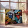 Cubist composition featuring geometric shapes in green and blue tones - beside a round wooden side table with books