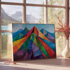 Cubist artwork featuring abstract shapes in greens and blues - beside a round wooden side table with books