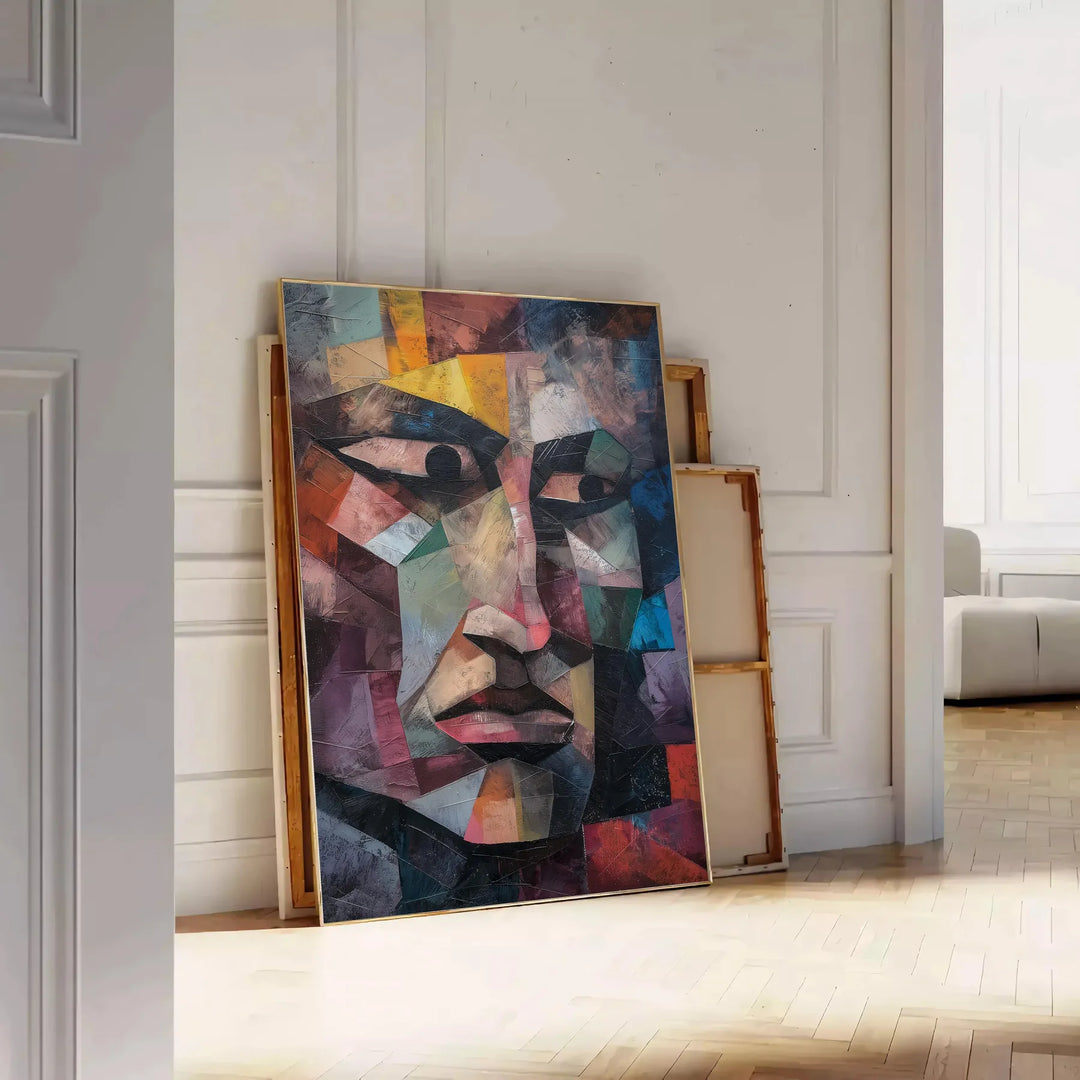Cubist artwork featuring geometric shapes in shades of green and blue - leaning on a herringbone floor against a white panelled wall
