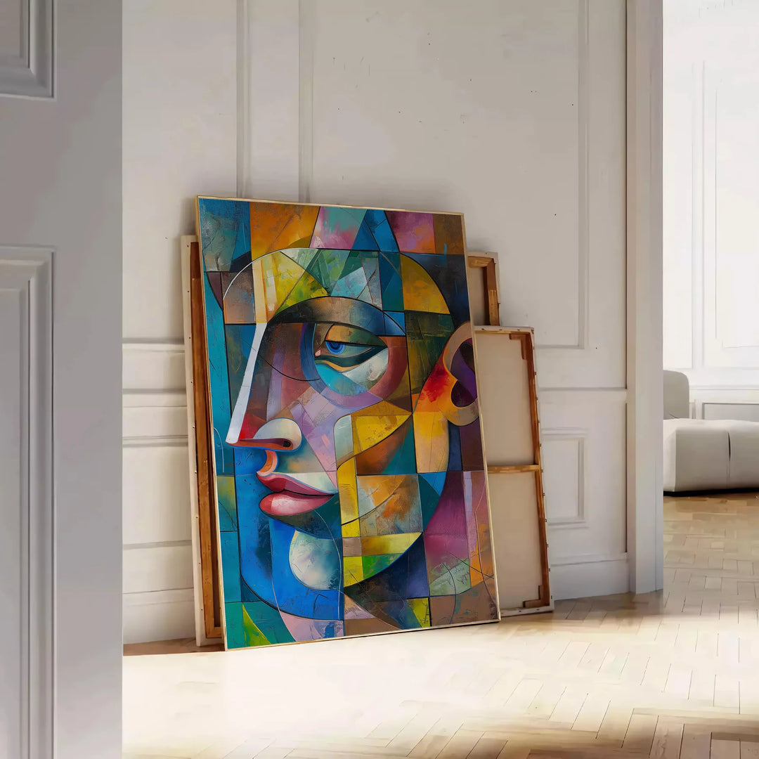 Cubist artwork featuring geometric shapes in green and blue tones - leaning on a herringbone floor against a white panelled wall