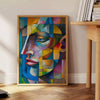 Cubist artwork featuring geometric shapes in green and blue tones - beside a round wooden side table with books