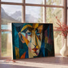 Cubist artwork featuring abstract shapes in green and blue tones - beside a round wooden side table with books