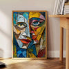 Cubist artwork featuring geometric shapes in green and gray tones - beside a round wooden side table with books