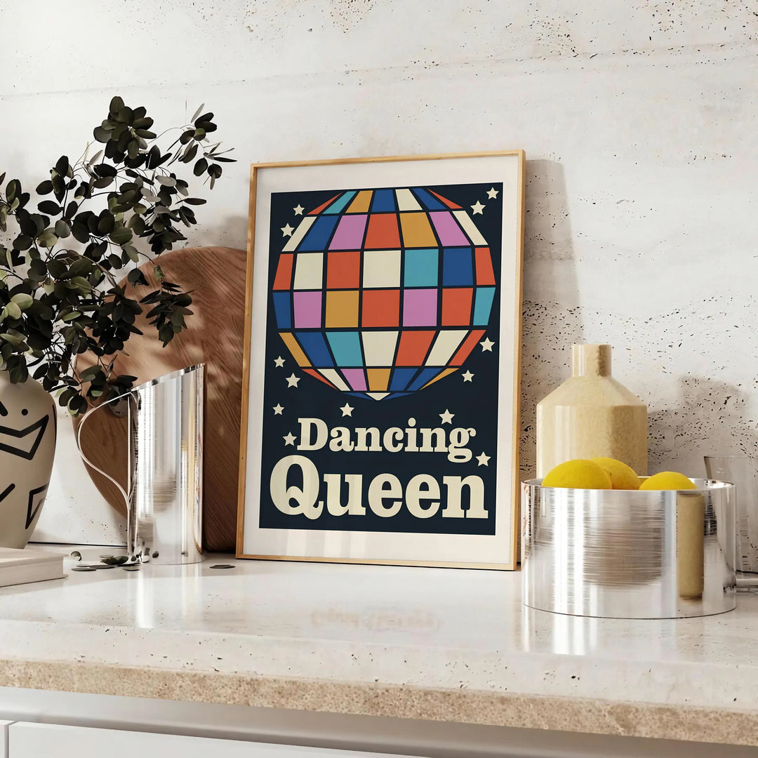 A retro-inspired poster featuring a dancing figure in orange and black hues - styled on a counter with eucalyptus and a bowl of lemons