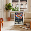 A retro-inspired poster featuring a dancing figure in orange and black hues - in a Parisian living room with a sofa and a fig plant