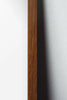 An oak frame surrounding a minimalist abstract design with earthy tones