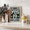 Vintage poster featuring bold black and orange design advocating marijuana decriminalization - styled on a counter with eucalyptus and a bowl of lemons