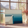 Abstract deep blue artwork with fluid shapes and soft white accents - beside a round wooden side table with books