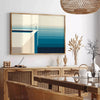 Abstract deep blue artwork with fluid shapes and soft white accents - in a Parisian living room with a sofa and a fig plant