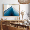 A deep blue abstract design with soft gray tones - in a Parisian living room with a sofa and a fig plant