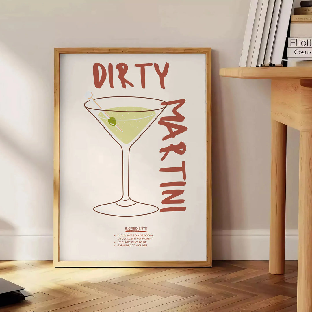Illustration of a dirty martini cocktail in a glass, with olive garnish - beside a round wooden side table with books