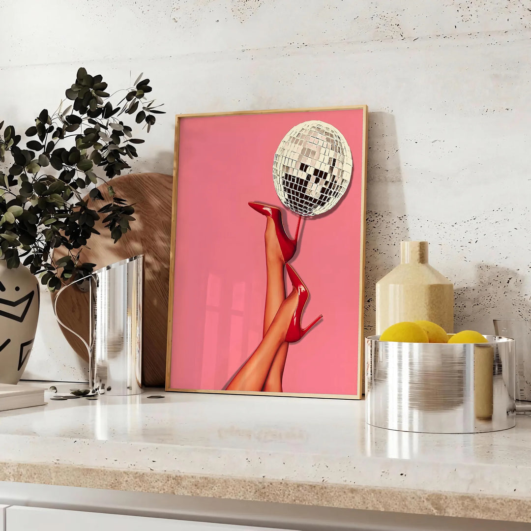A retro-style illustration of a disco foot in bold black and orange hues - styled on a counter with eucalyptus and a bowl of lemons