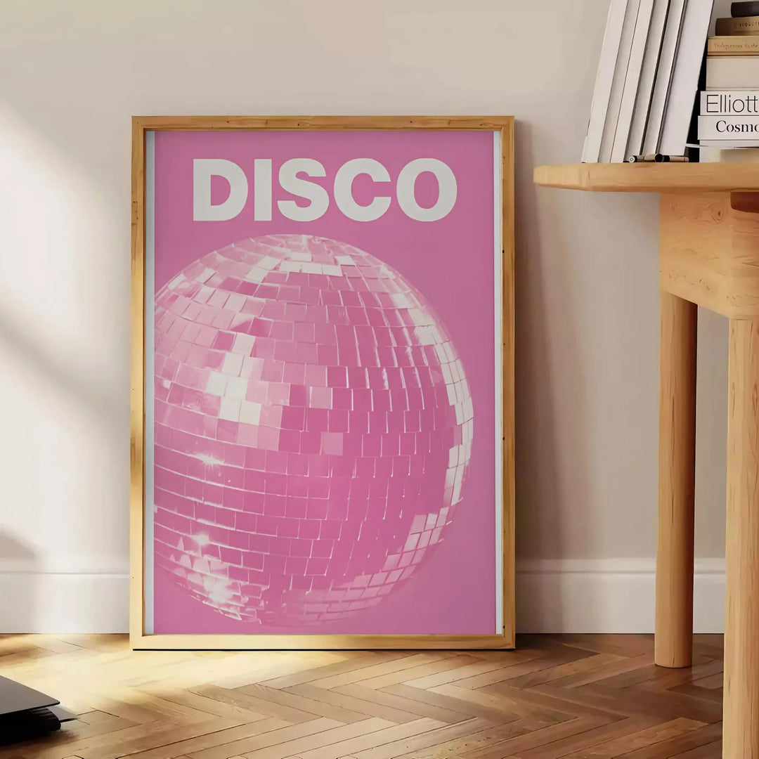 Abstract design featuring dynamic pink and orange shades reminiscent of disco themes - beside a round wooden side table with books