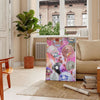 Abstract design featuring pink and purple hues with a disco theme - in a Parisian living room with a sofa and a fig plant