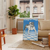 A dog floating in space with a starry background in blue and gray tones - in a Parisian living room with a sofa and a fig plant
