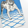 A dog floating in space with a starry background in blue and gray tones - as a rolled, unframed print