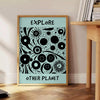 abstract representation of planets against a dark blue backdrop - beside a round wooden side table with books