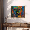 Abstract expressionist artwork featuring swirling green and blue forms - styled on a counter with eucalyptus and a bowl of lemons