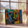 Abstract expressionist artwork featuring swirling green and blue forms - beside a round wooden side table with books