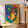 Abstract expressionism with green and blue hues, depicting creative energy - beside a round wooden side table with books