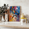Abstract expressionist artwork with green and blue color splashes - styled on a counter with eucalyptus and a bowl of lemons
