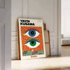 Abstract polka dot eyes in yellow and blue by Yayoi Kusama - leaning on a herringbone floor against a white panelled wall