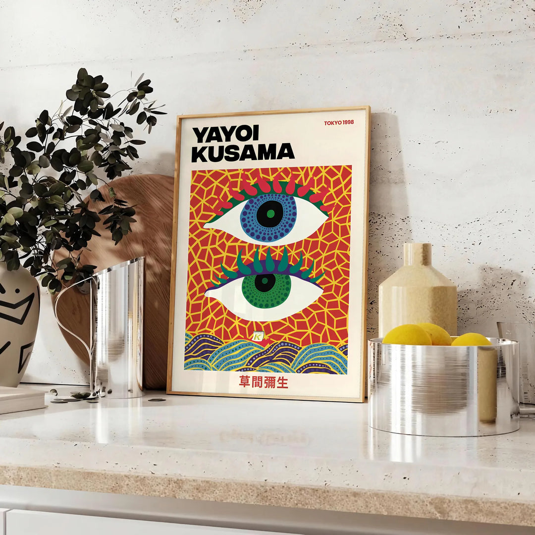 Abstract polka dot eyes in yellow and blue by Yayoi Kusama - styled on a counter with eucalyptus and a bowl of lemons