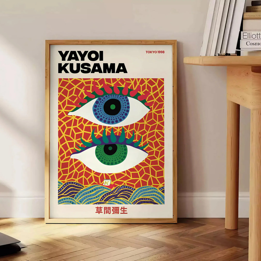 Abstract polka dot eyes in yellow and blue by Yayoi Kusama - beside a round wooden side table with books
