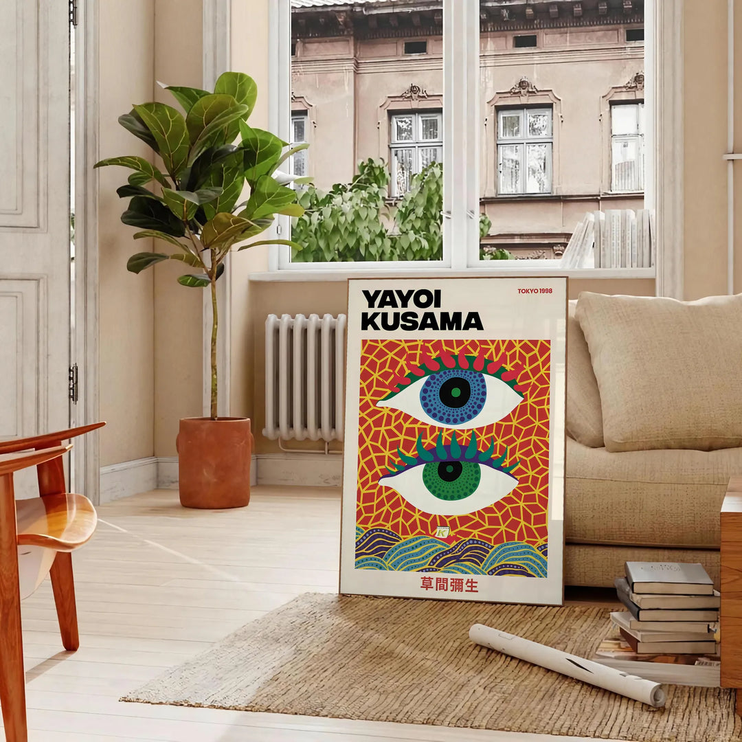 Abstract polka dot eyes in yellow and blue by Yayoi Kusama - in a Parisian living room with a sofa and a fig plant