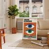 Abstract polka dot eyes in yellow and blue by Yayoi Kusama - in a Parisian living room with a sofa and a fig plant