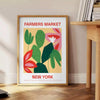 Botanical illustration featuring fresh greens and rich oranges from a farmer's market - beside a round wooden side table with books