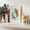 Detailed illustration of a black and green fish swimming in water - styled on a counter with eucalyptus and a bowl of lemons