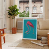 A pink flamingo standing gracefully against a soft blue background - in a Parisian living room with a sofa and a fig plant