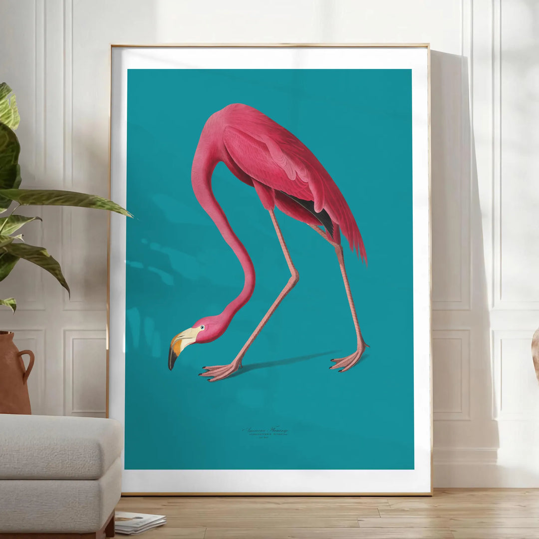 A pink flamingo standing gracefully against a soft blue background - in a bright minimalist room with a plant and an armchair