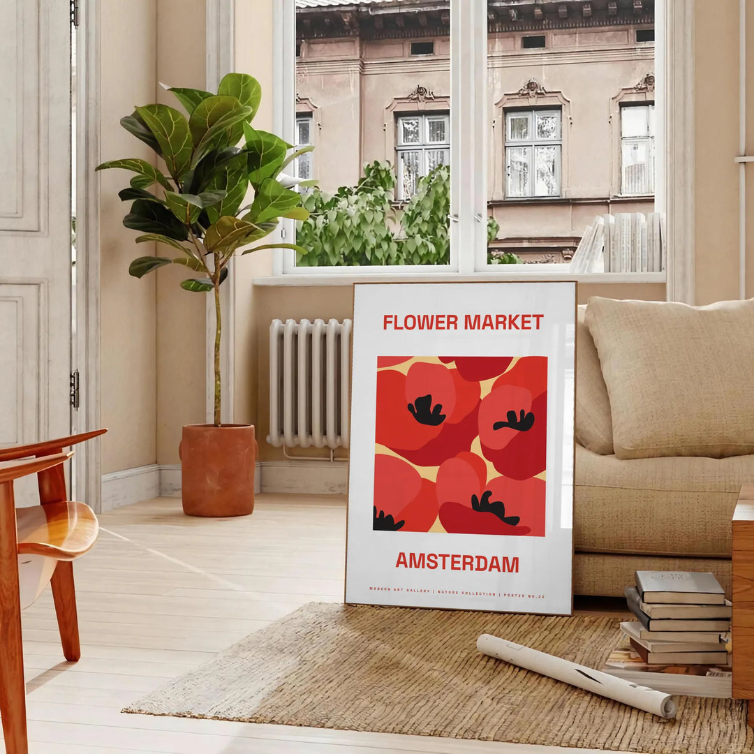 A colorful flower market scene with various blooms in orange and black tones - in a Parisian living room with a sofa and a fig plant